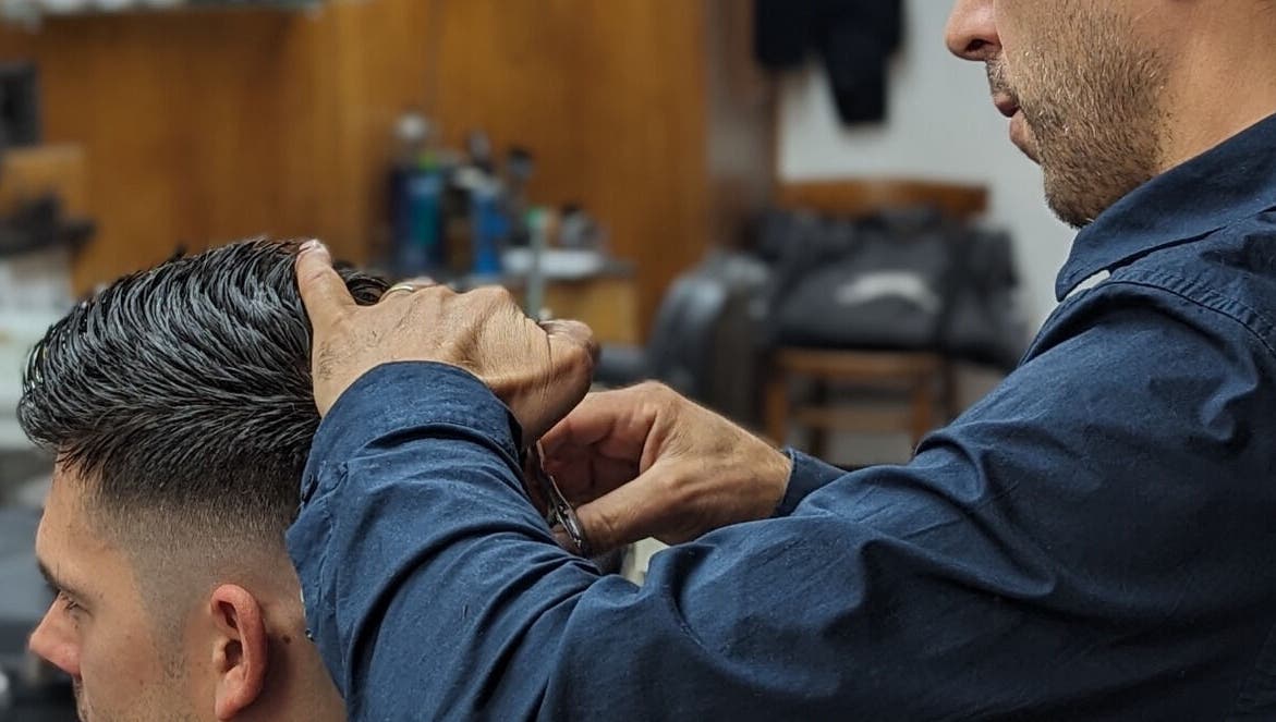 Professional haircut at Barber by Naz, London, England, GB. Close-up showing detailed hair styling.