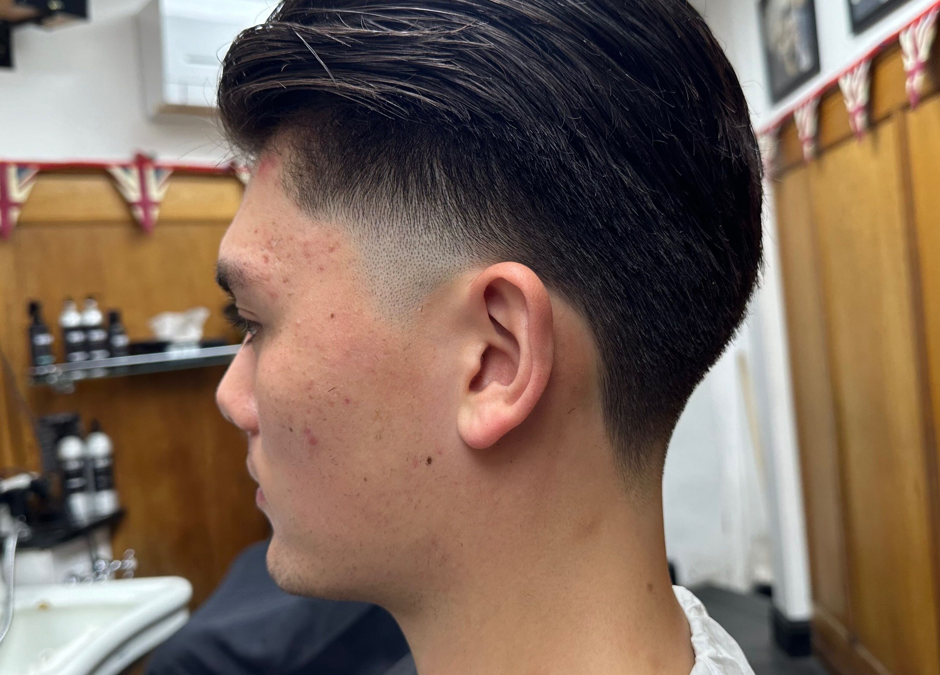 Close-up of a trendy haircut at Barber by Naz, London, England, GB, showcasing precise and modern styling.