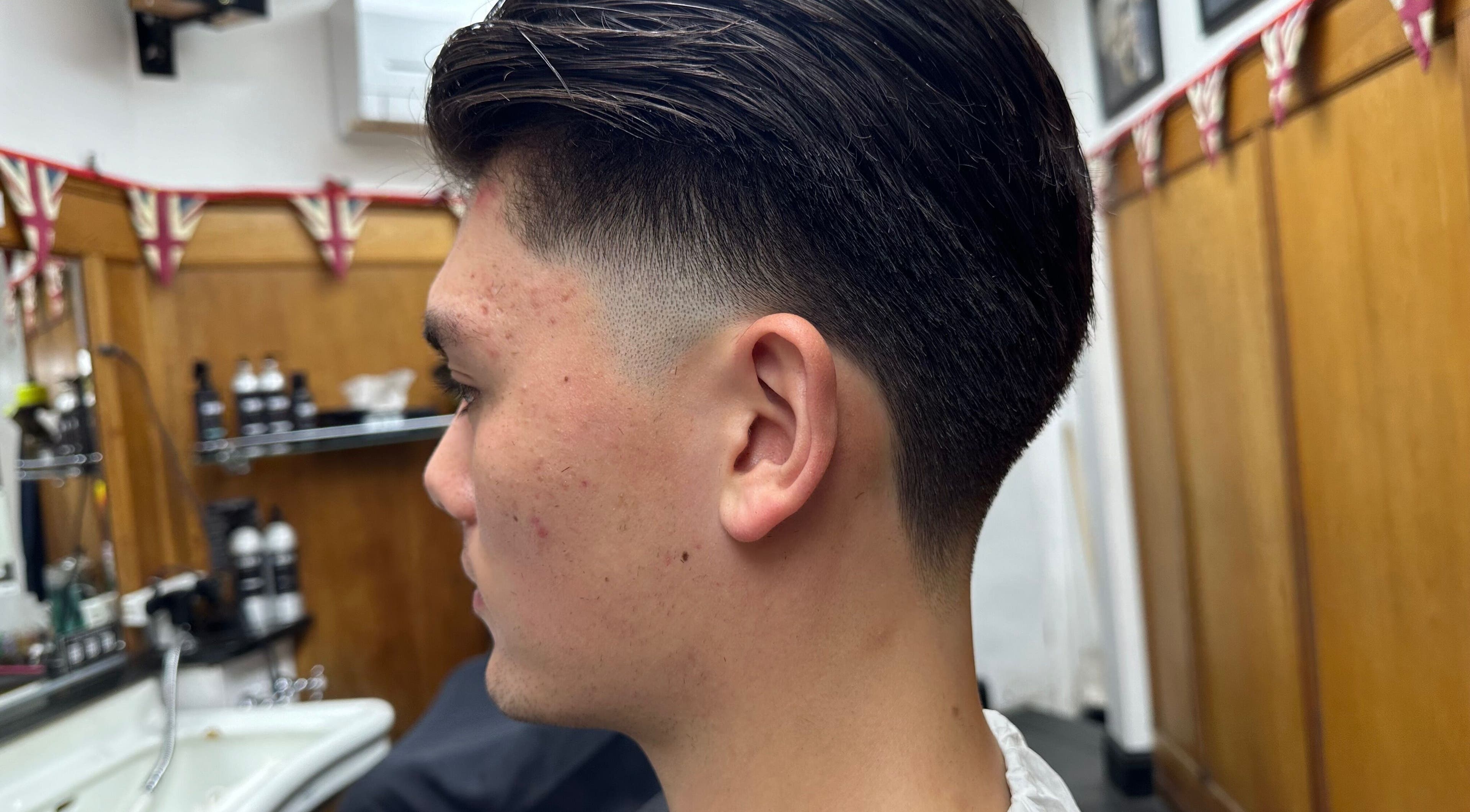 Close-up of a trendy haircut at Barber by Naz, London, England, GB, showcasing precise and modern styling.
