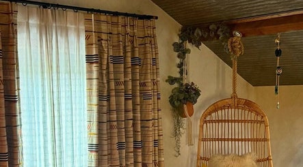 Relaxing corner with woven chair at The Sanctuary at Upper Farm, Tiffield, England, GB.
