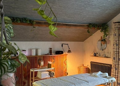 Cozy wellness room at The Sanctuary at Upper Farm, Tiffield, England, GB with massage table and calming decor.