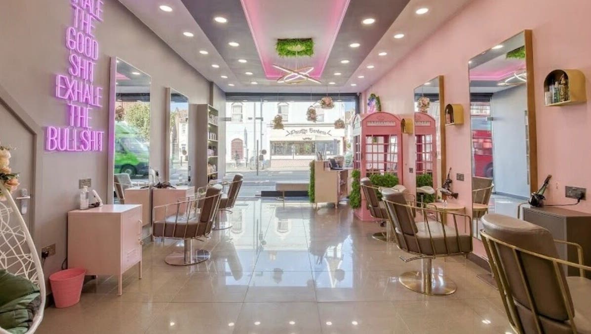 Modern beauty salon interior at Becks Lbl X, London, England, GB with pink decor and stylish chairs.