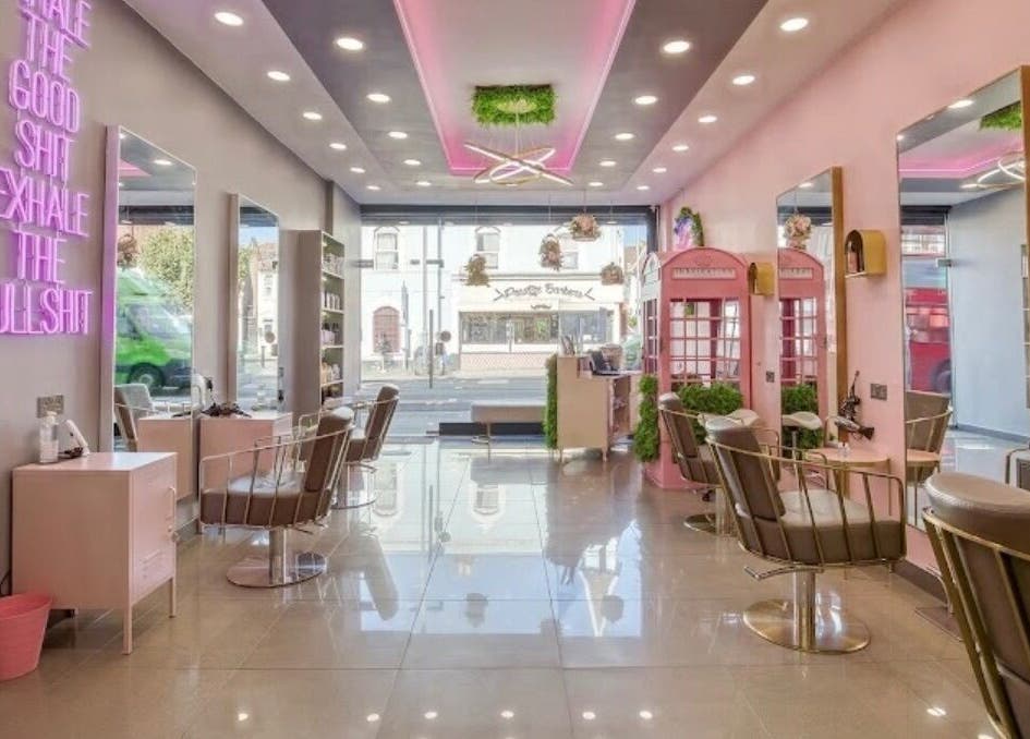 Modern beauty salon interior at Becks Lbl X, London, England, GB with pink decor and stylish chairs.