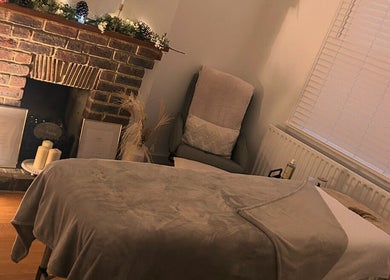 Relaxing massage room at Hollie’s Beauty Room, Eastbourne, England with rustic decor and warm lighting.