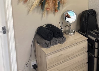 Cozy beauty setup at Glossy Lox with rolled towels and mirror in Hull, England, GB.