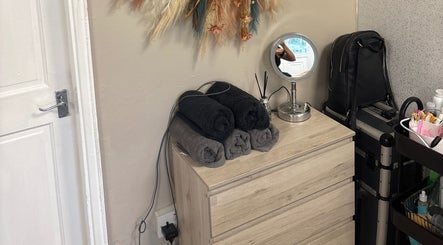 Cozy beauty setup at Glossy Lox with rolled towels and mirror in Hull, England, GB.