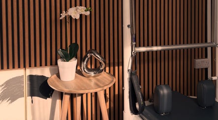 Elegant Pilates setup at Aisha Tannahill Pilates, Richmond, England, GB with plants and modern decor.
