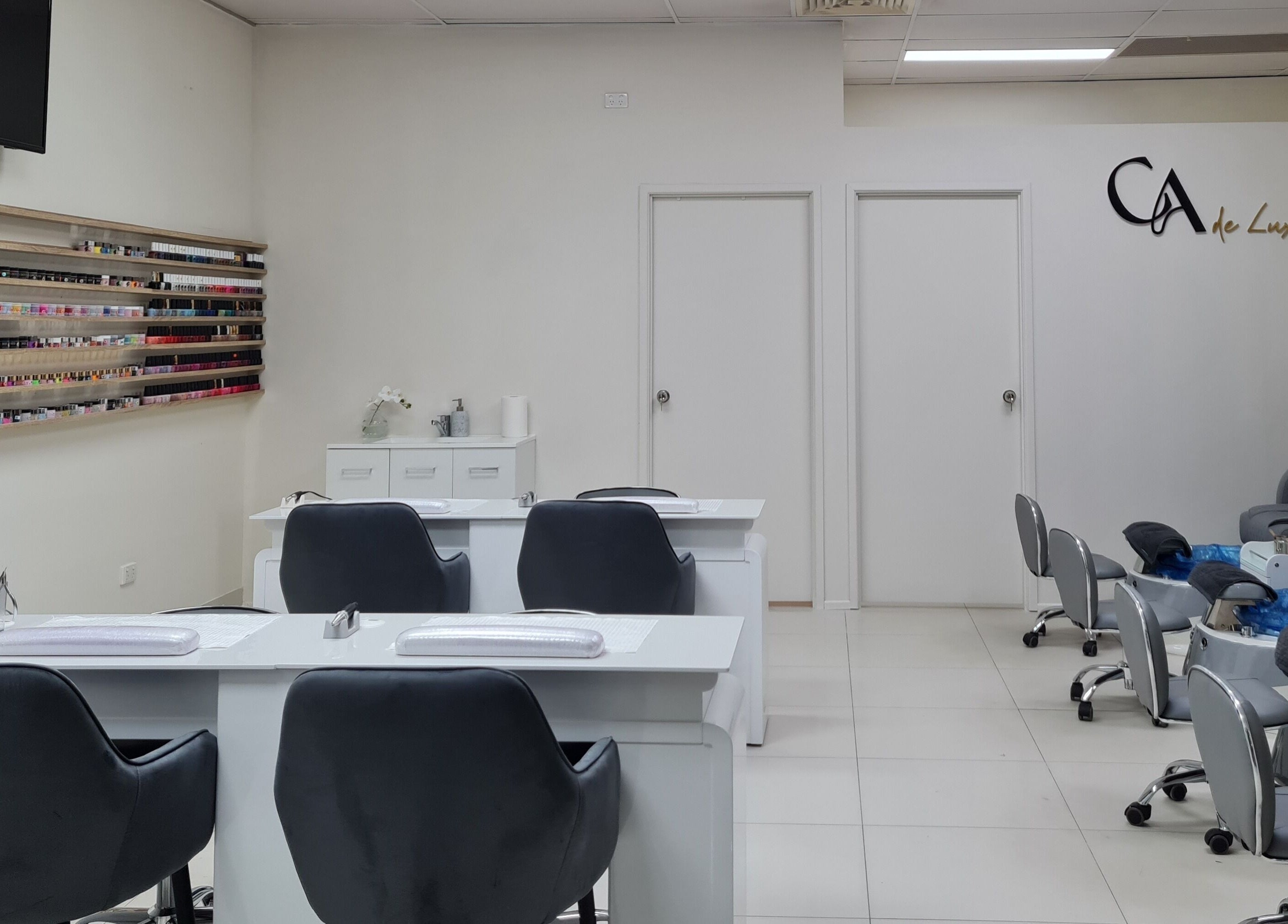 Elegant interior of CA de Luxe Nails, Oxenford, Queensland, AU. Modern manicure stations and pedicure chairs.
