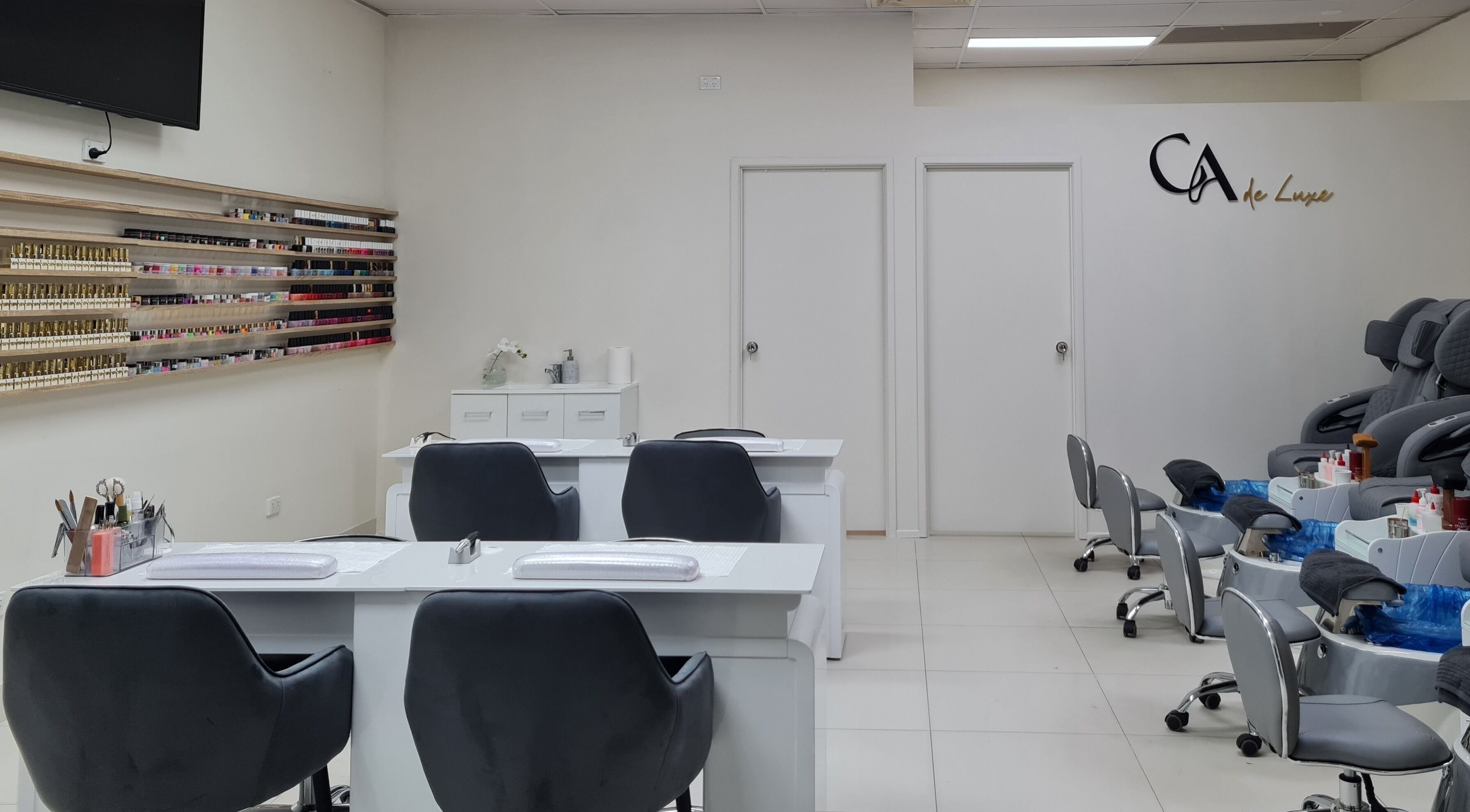 Elegant interior of CA de Luxe Nails, Oxenford, Queensland, AU. Modern manicure stations and pedicure chairs.
