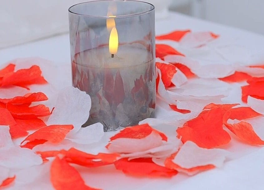 Candle with rose petals at J&M SPA KENYA, Mombasa, Mombasa County, KE, creating a serene atmosphere.