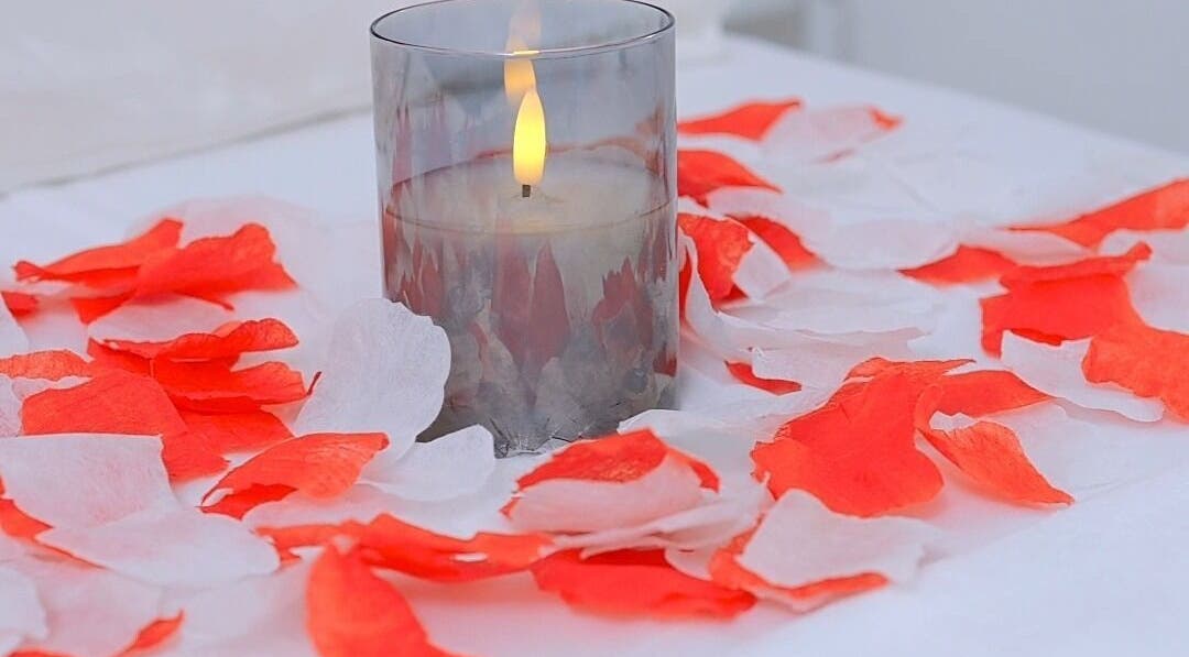 Candle with rose petals at J&M SPA KENYA, Mombasa, Mombasa County, KE, creating a serene atmosphere.