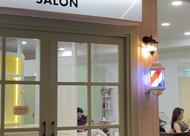 Exterior view of Stylistfai salon at Krung Thep Maha Nakhon with a welcoming open sign.