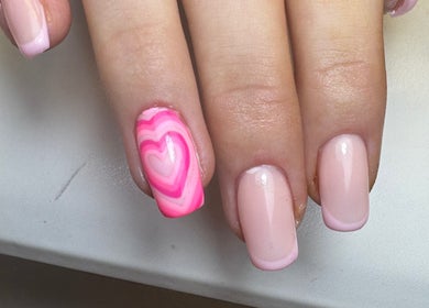 Pink heart nail art at Molly’s Nail Club, Birmingham, England, GB offering creative manicure designs.