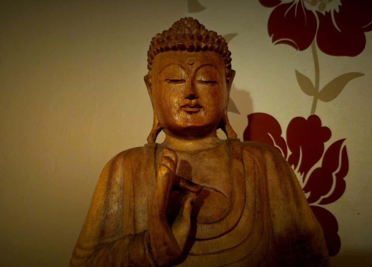 Wooden Buddha statue at Emma Meredith International Reiki Practitioner, Chertsey, England, GB.