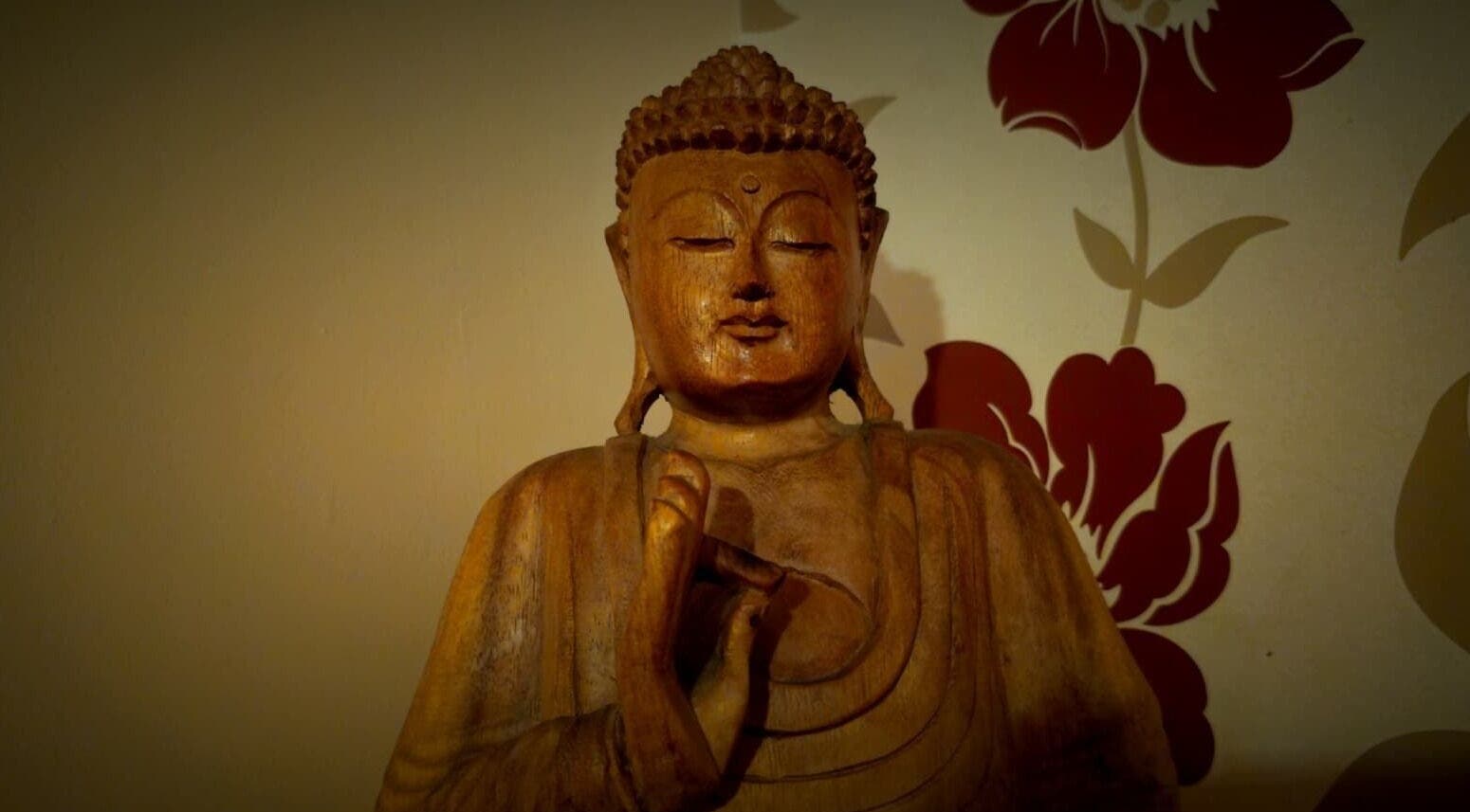 Wooden Buddha statue at Emma Meredith International Reiki Practitioner, Chertsey, England, GB.