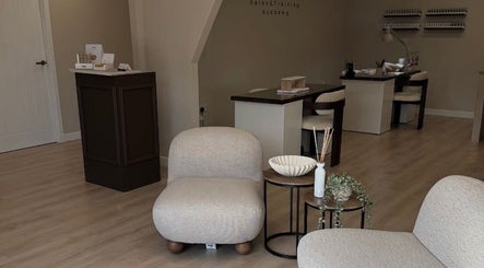 Modern interior of Vida Brows & Lashes in Hamilton, Scotland, GB featuring cozy seating and elegant decor.