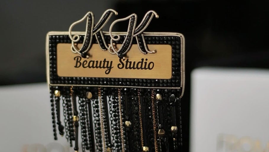 Elegant K.K Beauty Studio sign in London, England, GB with intricate black and gold details.