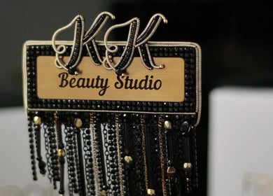 Elegant K.K Beauty Studio sign in London, England, GB with intricate black and gold details.
