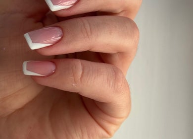 Elegant French manicure at K.K Beauty Studio, London, England, GB, showcasing neat white tips.