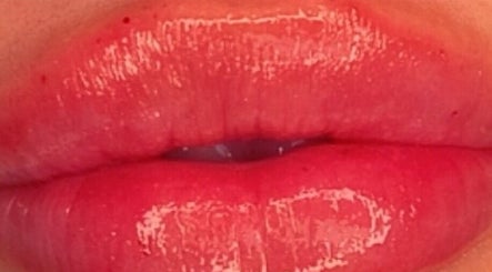 Glossy red lips beauty treatment at Rumours Aesthetics, Clonmel, County Tipperary, IE. Shine and allure enhanced.