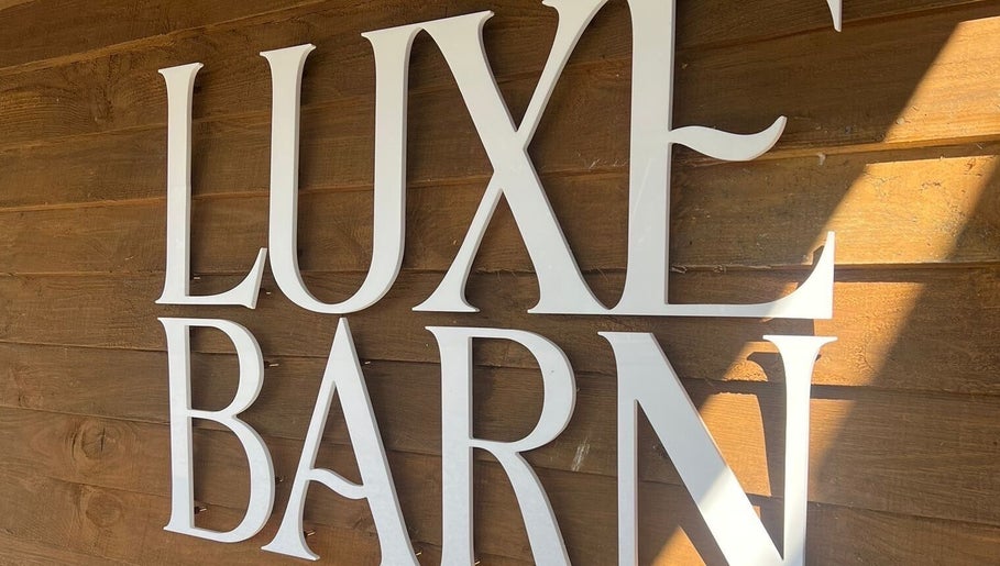 Luxe Barn sign on wood wall at Meg Eliot Hair in Clevedon, England, GB.
