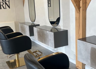 Modern salon chairs and mirrors at Meg Eliot Hair in Clevedon, England, GB.