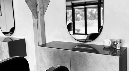 Modern salon interior with mirrors at Meg Eliot Hair, Clevedon, England, GB. Sleek design and elegant decor.