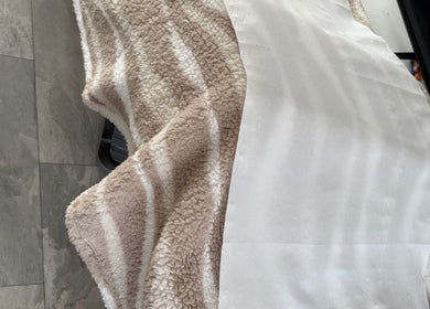 Soft, textured blanket on table at Lashesdunnebyh, Wishaw, Scotland, GB. Ideal for maximum comfort.