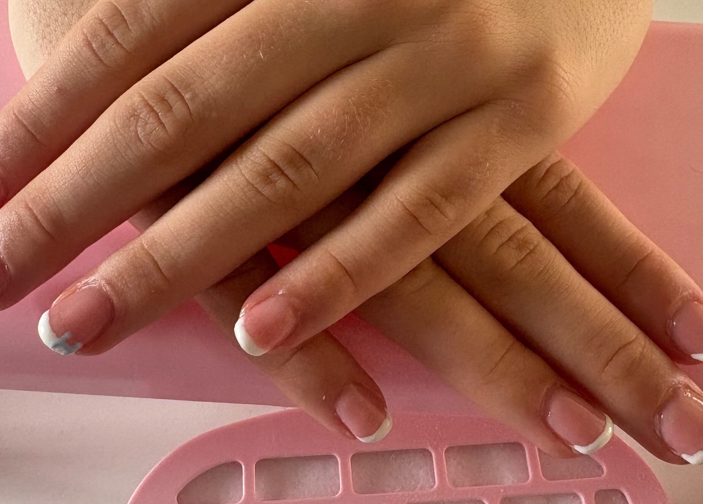 Elegant French manicure at CM Biab, Filton, England, GB, showcasing glossy, well-groomed nails.