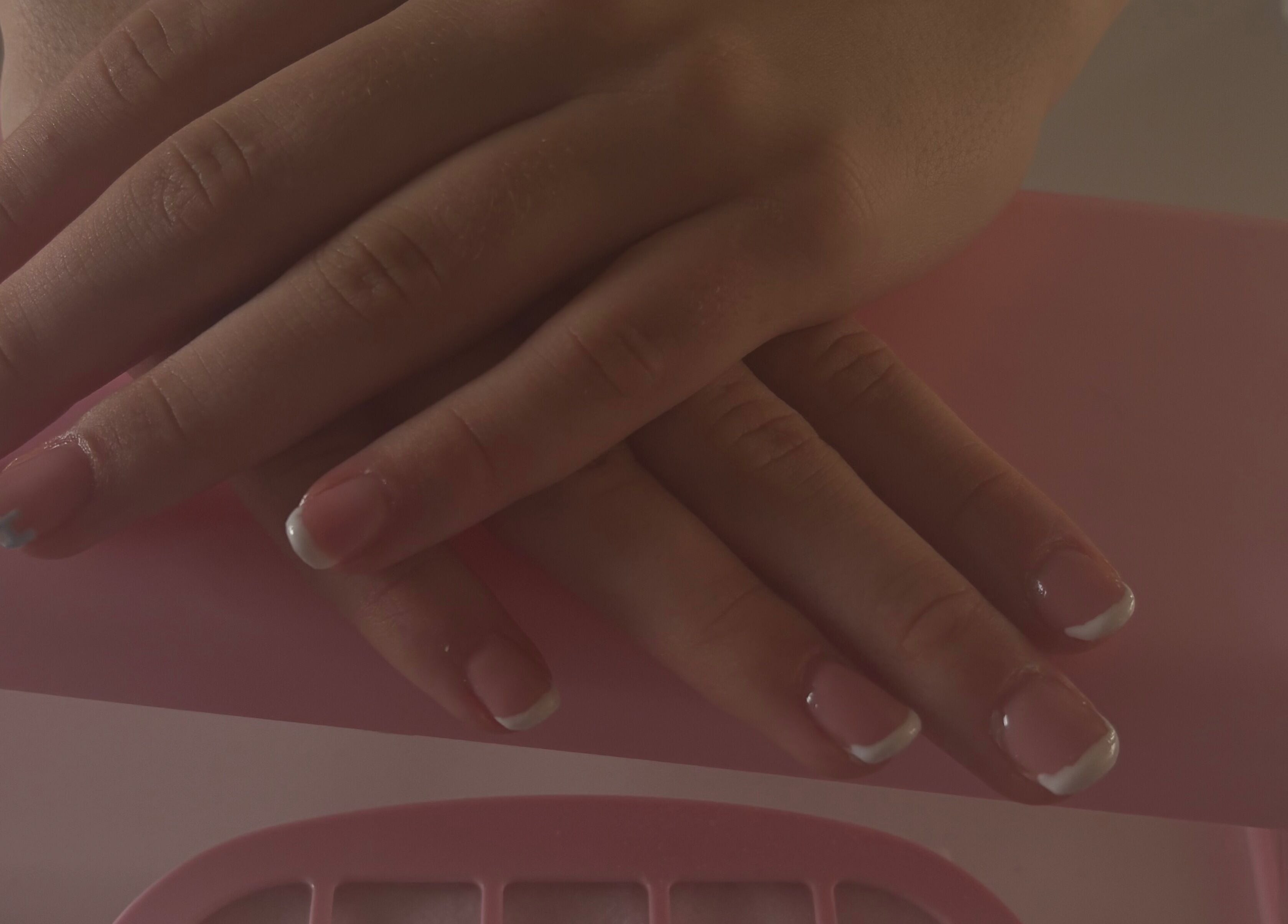 Elegant French manicure at CM Biab, Filton, England, GB. Showcases delicate nail art with a glossy finish.