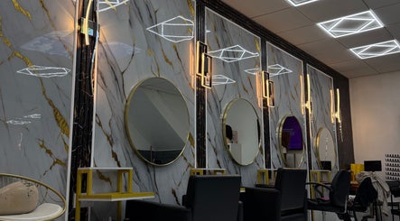 Elegant salon interior with round mirrors and modern lighting at Rim’s Hairdressing, Sheffield, England, GB.