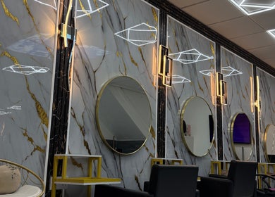 Luxurious salon mirrors at Rim’s Hairdressing, Sheffield, England, GB, featuring gold accents and modern decor.