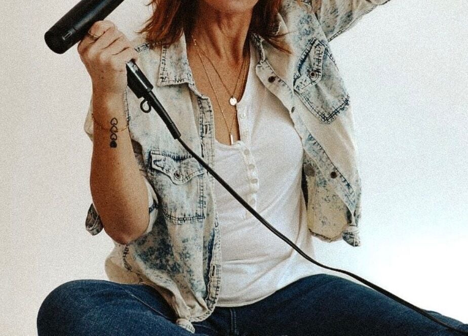 A stylist with a hair dryer at Beauty in A Bottle Aesthetics and Salon in Sherman, Texas, US.