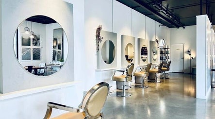 Chic interior of Hair by Sarah, Auckland, NZ, featuring stylish mirrors and chairs.