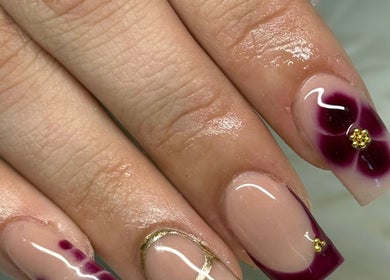 Elegant floral nail art with gold accents at Beautyby_evie_x, Wisbech, England, GB.