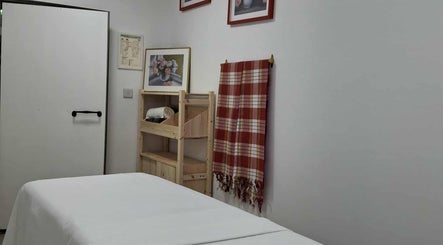 Calm massage room at Ottoman Novus Spa, Dublin, County Dublin, IE with a bed and relaxing decor.