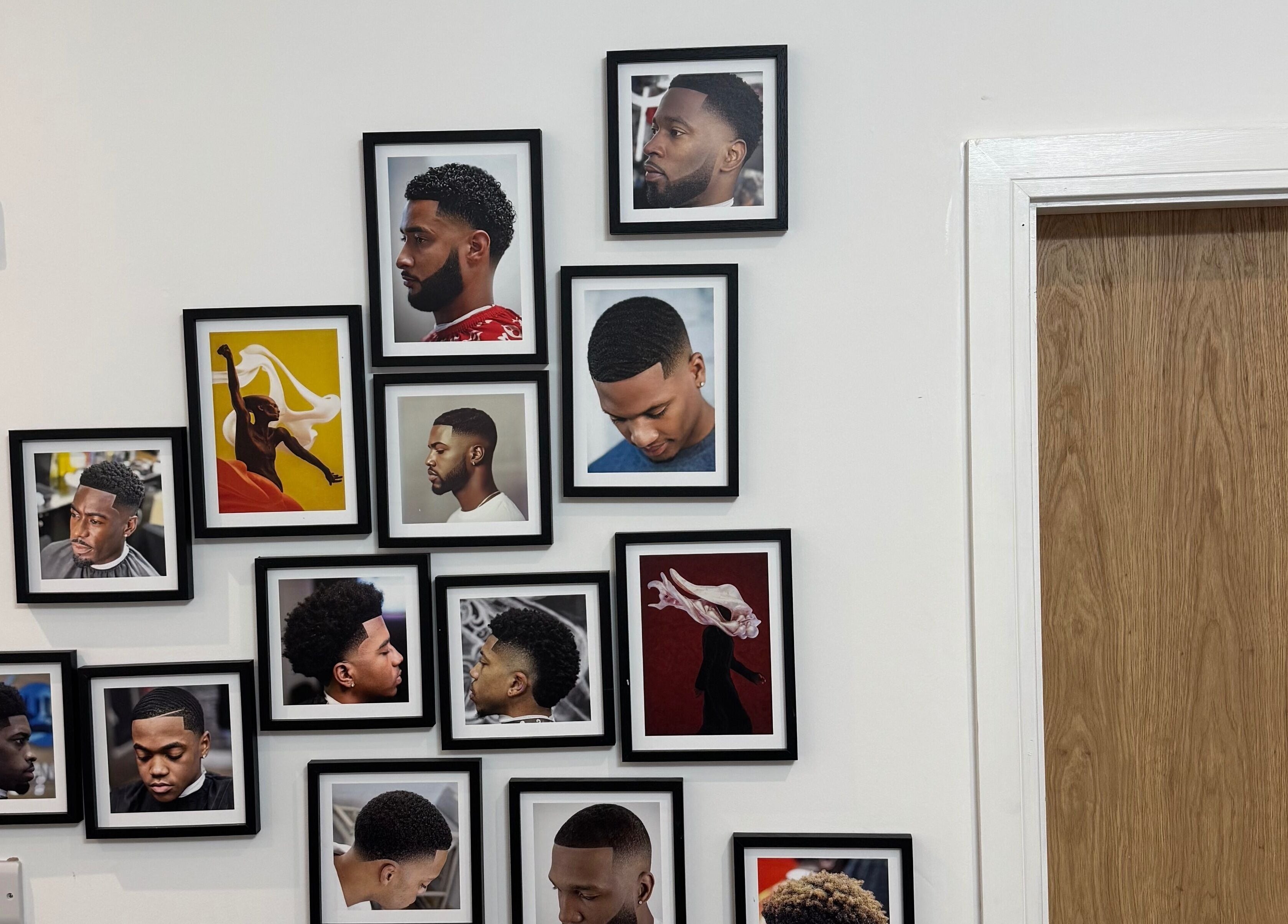 Gallery wall at Edward Cut Studio, Bradford, England featuring diverse hairstyles in stylish frames.