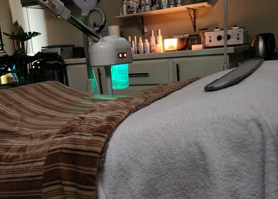 Cozy spa room at Beautiful Bodies, Warrenville, Cunupia, TT with massage table and calming ambiance.