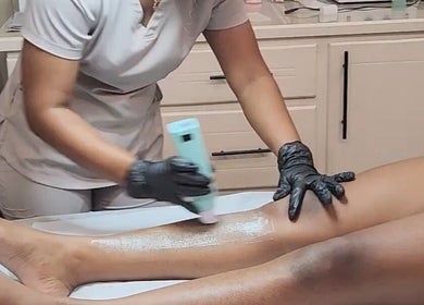 Aesthetician providing leg care treatment at Beautiful Bodies, Warrenville, Cunupia, TT.