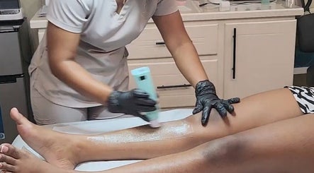 Aesthetician providing leg care treatment at Beautiful Bodies, Warrenville, Cunupia, TT.