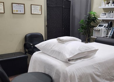 Relaxing treatment room at Beautiful Bodies, Warrenville, Cunupia, TT featuring white linens and modern equipment.