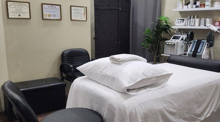 Relaxing treatment room at Beautiful Bodies, Warrenville, Cunupia, TT featuring white linens and modern equipment.