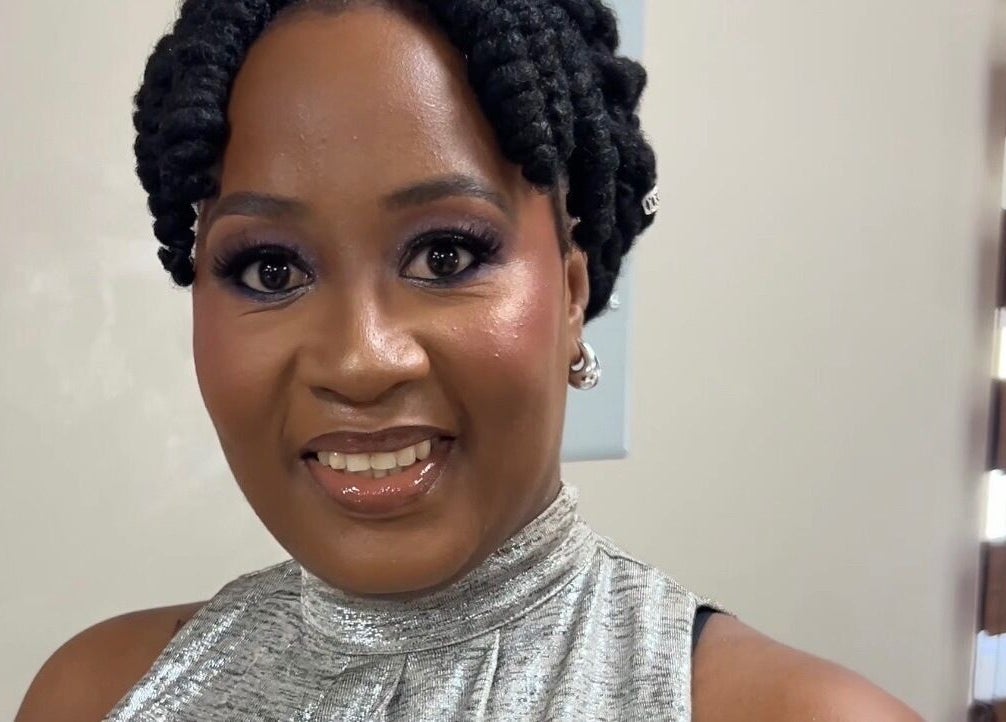 Smiling woman with styled hair at The Island Beauty, Arima, Arima Borough Corporation, TT.