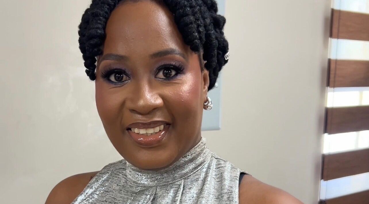 Smiling woman with styled hair at The Island Beauty, Arima, Arima Borough Corporation, TT.