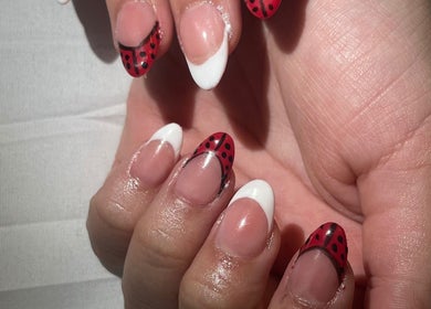 Creative ladybug-themed nails at Nails by Jear, Mansfield, Connecticut, US.