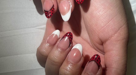 Creative ladybug-themed nails at Nails by Jear, Mansfield, Connecticut, US.