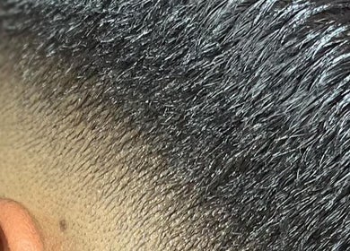 Close-up of a fresh haircut fade at Brito_TheBarber, Paramaribo, Paramaribo, SR showcasing expert styling.