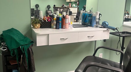 The Style Lab Beauty Salon in Bentleyville, PA features a styling station with products and a mirror.