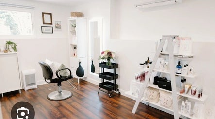 Chic salon interior at Cynthia Beauty, Spring Lake, North Carolina, US, showcasing modern styling chair and products.