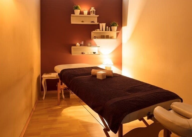 Cozy massage room at Mobile - Velvet Touch Maalish, Hounslow, England, GB, with warm lighting and tidy decor.